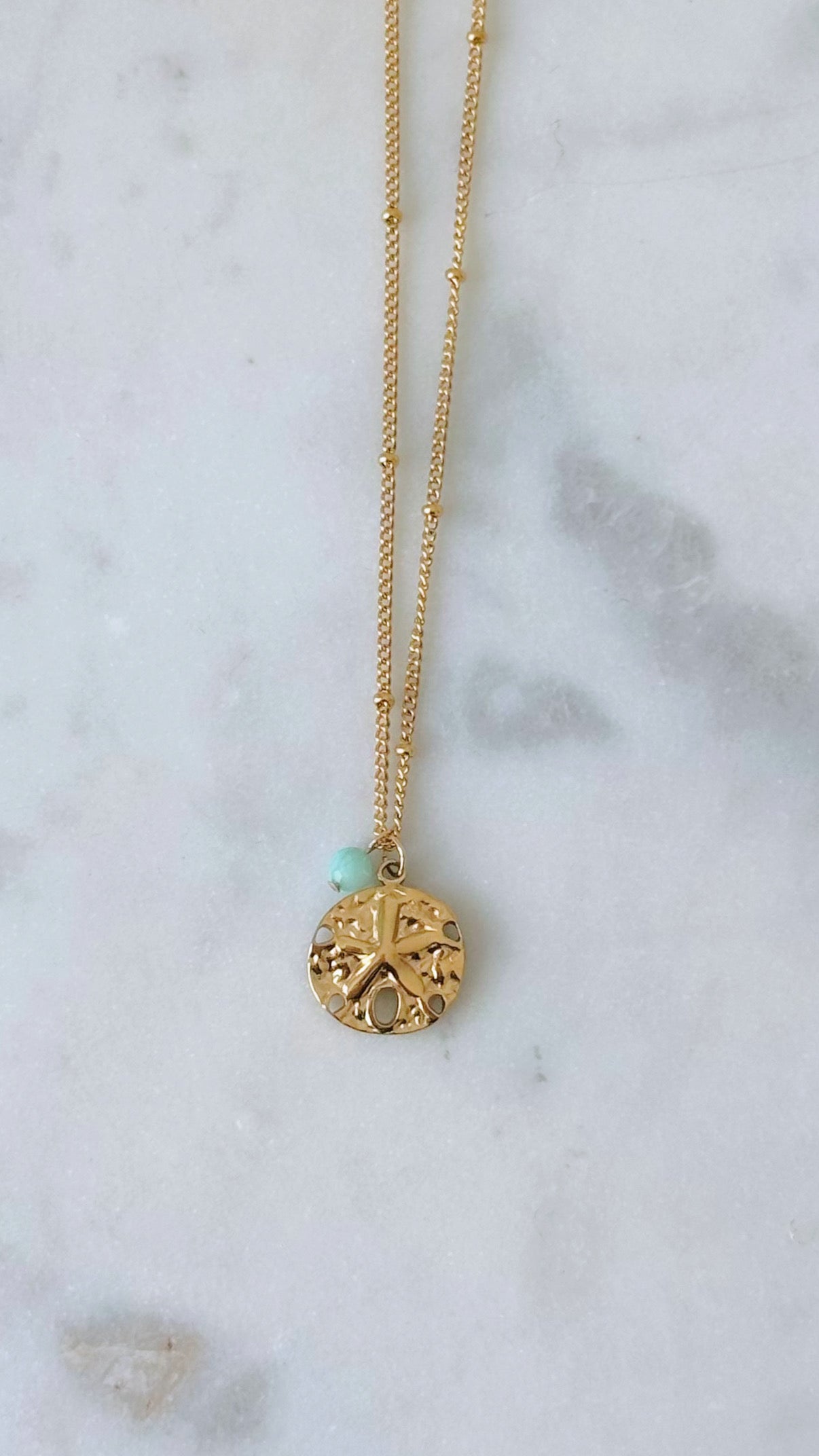 Gold sand dollar necklace