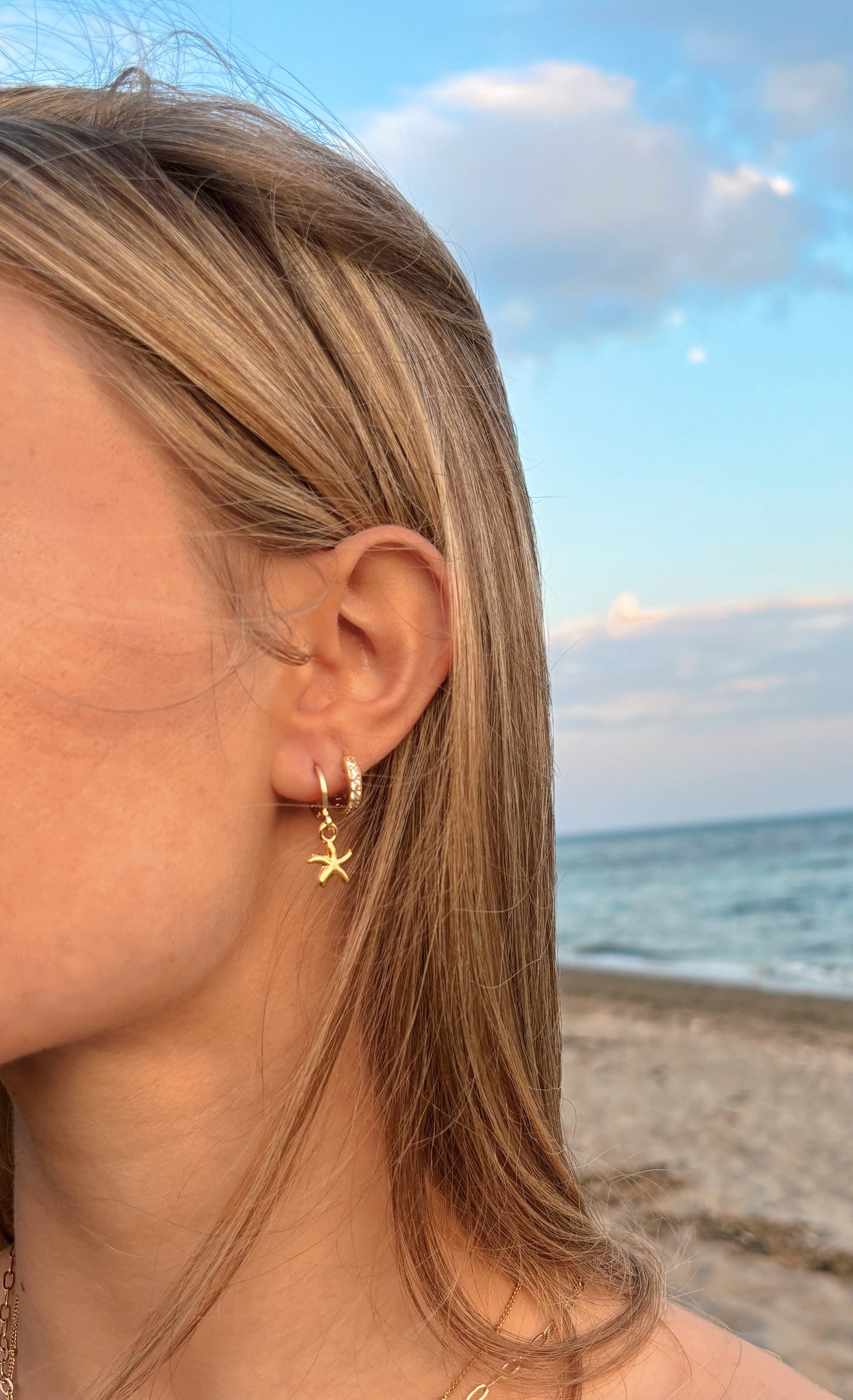 Gold starfish huggie earrings