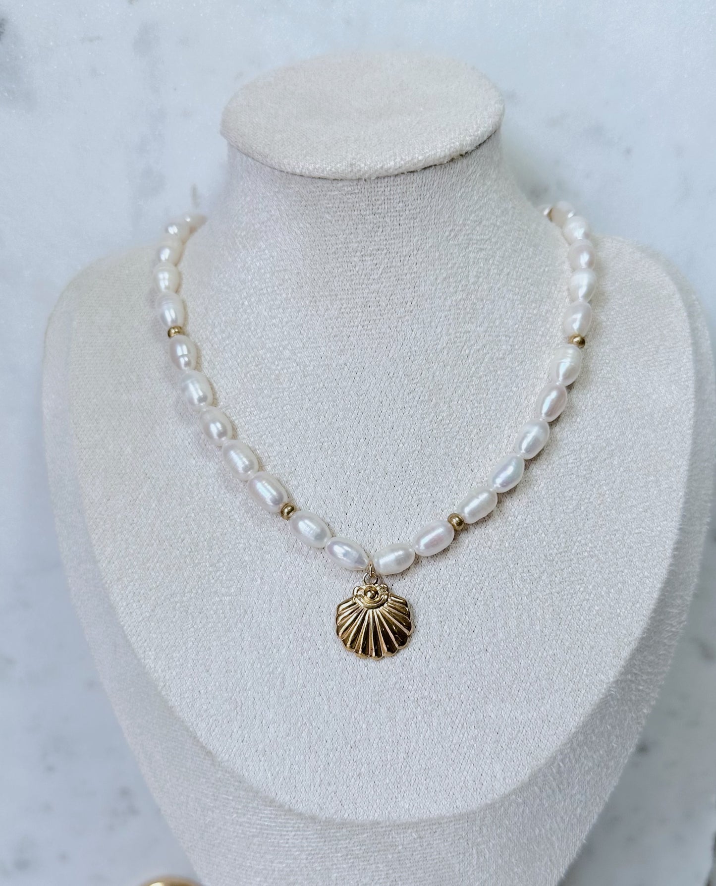 Chunky pearl & gold charm necklace