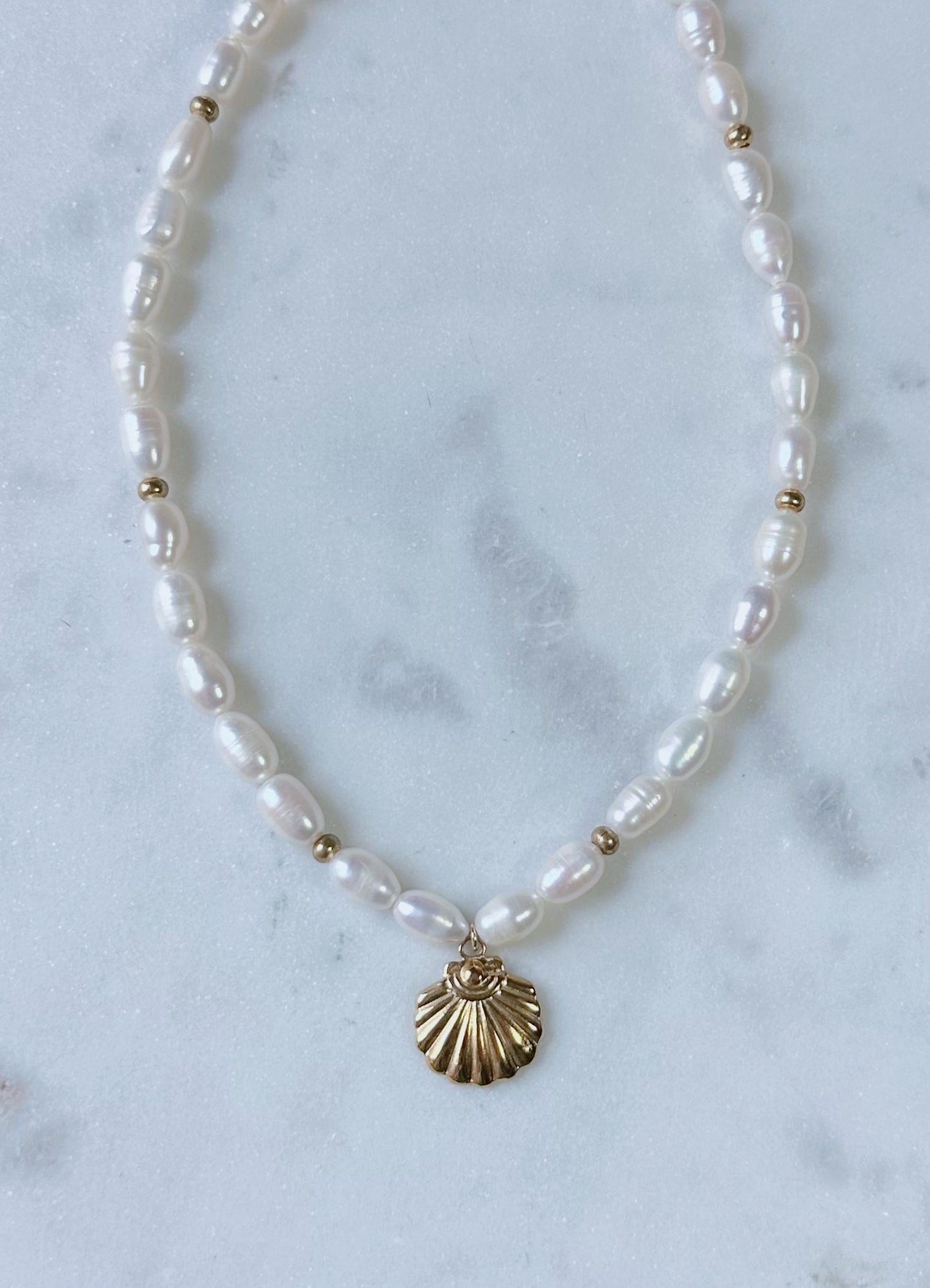 Chunky pearl & gold charm necklace