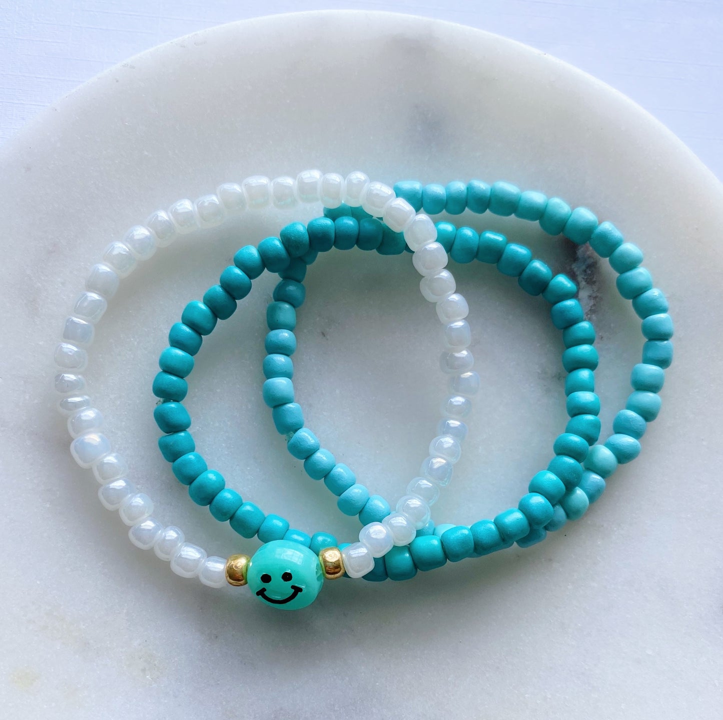 Blue smiley beaded bracelet stack