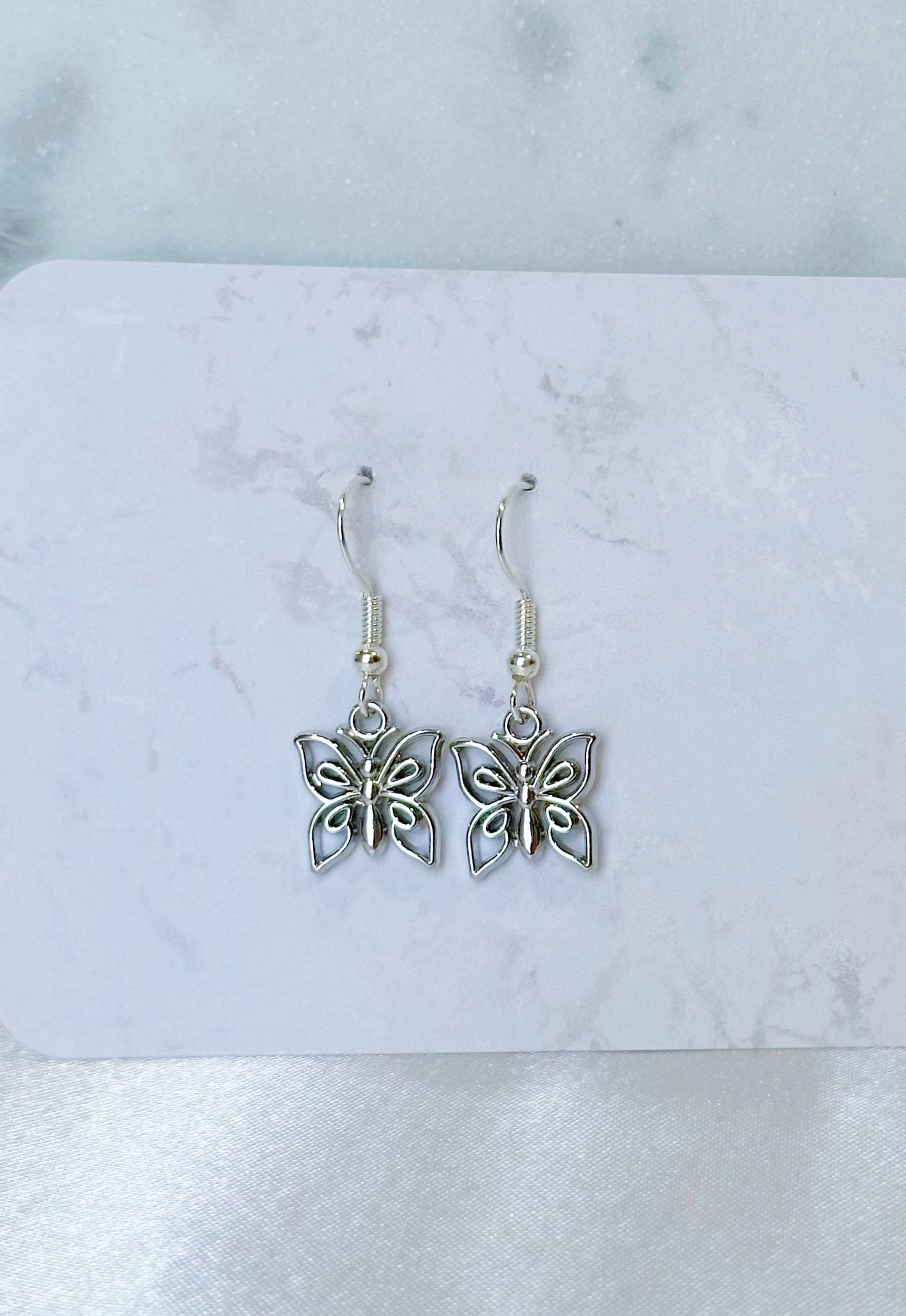 Dainty butterfly charm earrings